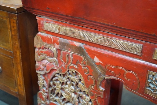 A Chinese carved scarlet and gilt painted altar table with faux stone top, length 198cm, depth 41cm, height 98cm